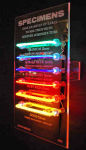 <b>Specimens</b>, 2009<br>Rare luminous tubes, electrical components, Pyrex, 30x18 inches<br>$2600
